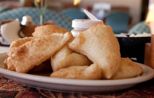 A plate of golden fried dough pieces.