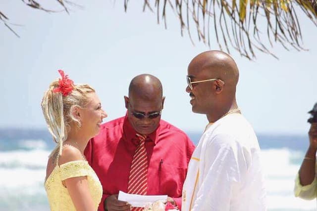 A couple saying their vows on a sandy beach